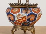 a decorative bowl on a stand on a table