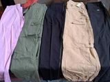three pairs of men ' s cargo pants sitting on top of a box