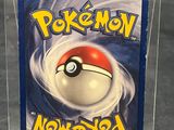 the pokemon card is in a clear plastic box on a table