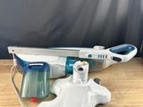 a white and blue steam mop on a wooden table