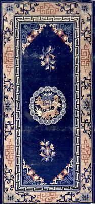 an oriental rug with a blue background and a gold border