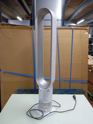 a white table with a fan on it in a room