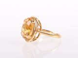 a close up of a gold ring with a citrine stone