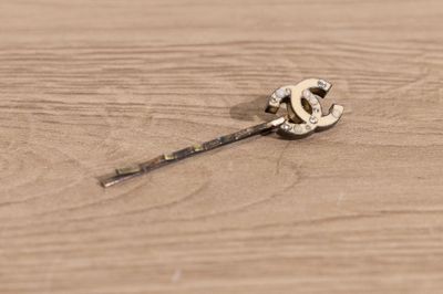 a small piece of jewelry on a wooden table