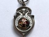 an image of a silver keychain with a picture of an owl on it