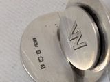 a close up of a metal button on a white surface