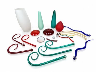 a group of different colored glass items on a white surface