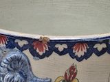 a blue and white vase with a bird on it