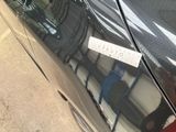 a sticker on the door of a black car