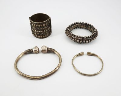 three silver bracelets and a ring