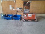 two blue bins and a cart in a garage
