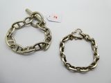 two silver bracelets and a chain bracelet