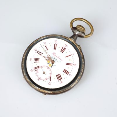 une montre de poche posée sur une surface blanche