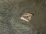 a close up of a metal pan with a knife in it