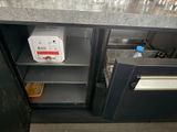 a small refrigerator that is open on the side of the counter