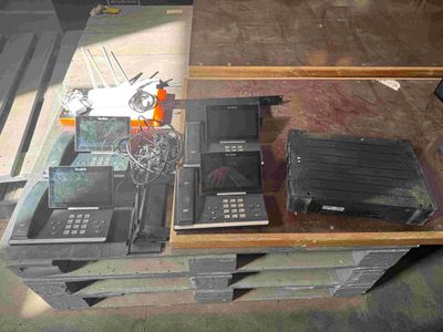several cell phones are sitting on top of a pallet on a table