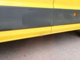 a yellow car with a black stripe on the side of it
