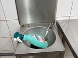 a sink with a toothbrush in it in a public bathroom