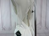 a white dress with a hood on a mannequin stand