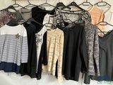 a lot of clothes hanging on a rack in a room