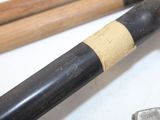 two baseball bats and a clamp on a table