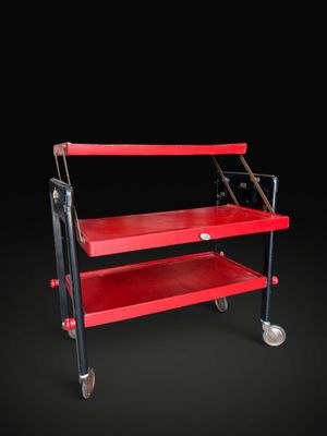 an image of a red utility cart on wheels against a black background