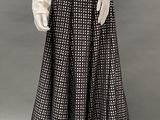 an image of a mannequin wearing a white shirt and black and white checkered skirt