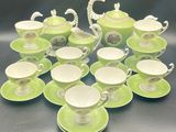 many cups and saucers sitting on a table