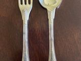 two spoons and a fork sitting on a table