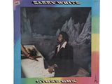 the album cover shows a man sitting at a table with an iceberg in the background