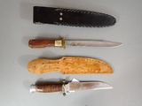 several different types of knives are lined up on a table