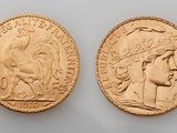 two gold sovereigns, one of which has a head of a woman and one of which has a head