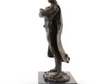 bronze statue of a man holding a baseball bat on a marble base