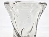 a glass vase that is sitting on a white surface