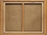 a close up of an old wooden window with a burlock covering