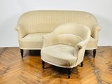 a couch and a chair sitting on a wooden floor