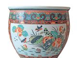 a large vase with a bird and flowers on it