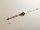 an image of a silver watch with a purple stone on it