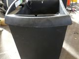 an image of a black trash can in a garage
