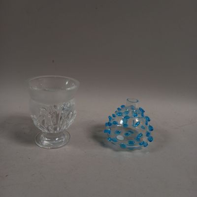 two glass vases sitting next to each other on a table