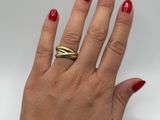 a woman ' s hand with a red manicure and a gold ring