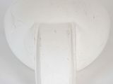 a white vase sitting on a white surface with a white background