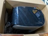 a blue suitcase sitting in a cardboard box on the floor