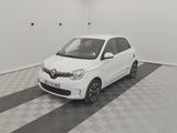 a picture of a small white car parked in a garage