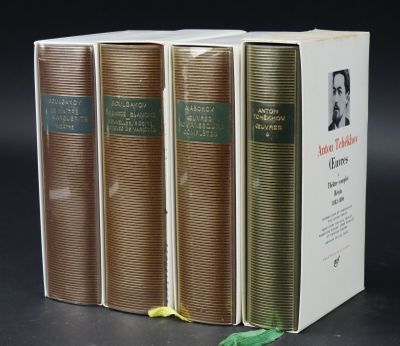 three books are stacked on top of each other on a table