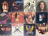 many different album covers on the wall of a room