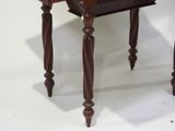 a small wooden table with a drawer on top of it