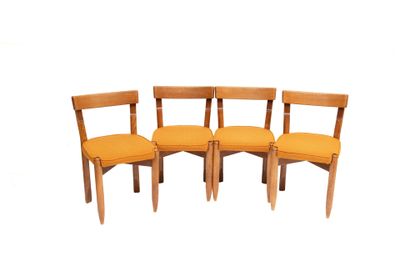 three wooden chairs with orange cushions sit side by side on a white surface