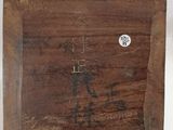an image of a wooden plaque with writing on it on a white surface