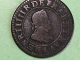 a close up of a coin on a green surface